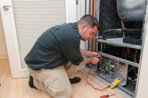 Technician Installing an Electric Furnace