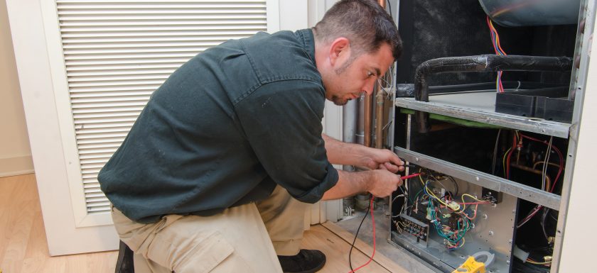 Technician Installing an Electric Furnace